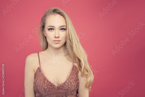 Young beautiful woman with long curly hair and natural makeup portrait