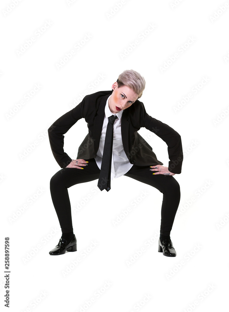 Woman wearing a suit with black pants, shirt and tie. Full body, crouching on a white background