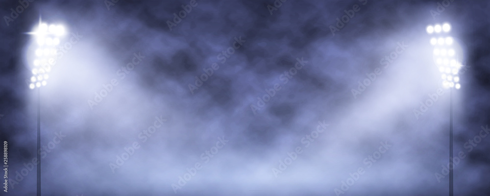 Spotlight Towers on Night Stadium in Smoke.