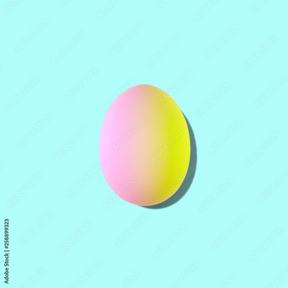 Easter egg in duotone colors on turquoise background. Minimal styled concept.