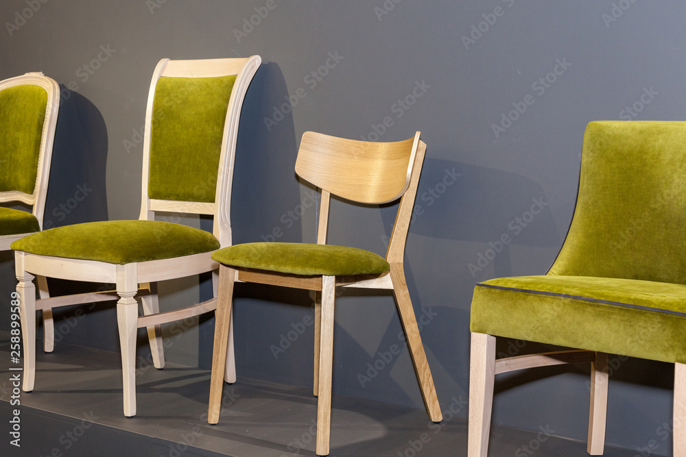 wooden chairs with green upholstered near grey wall wooden chairs with green upholstered near grey wall