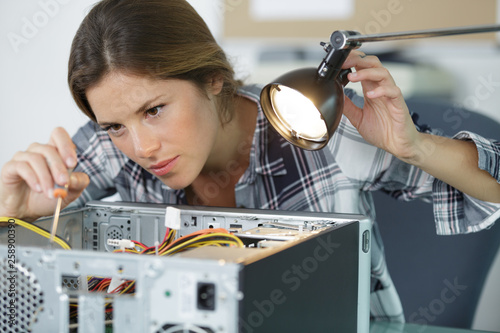 woman technician fixing a computer