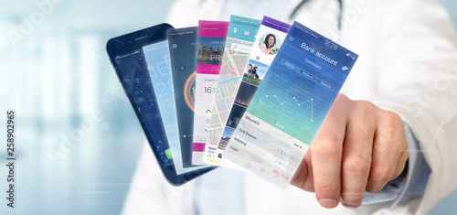 Doctor holding Mobile application template on a smartphone 3d rendering