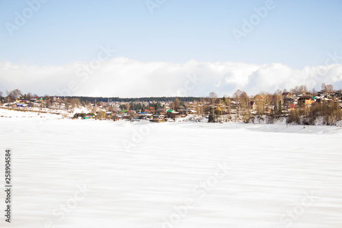Village across the river. Real Russian Winter. Winter Landscape in river. Country house on lake shore in winter © Ольга Шапкина
