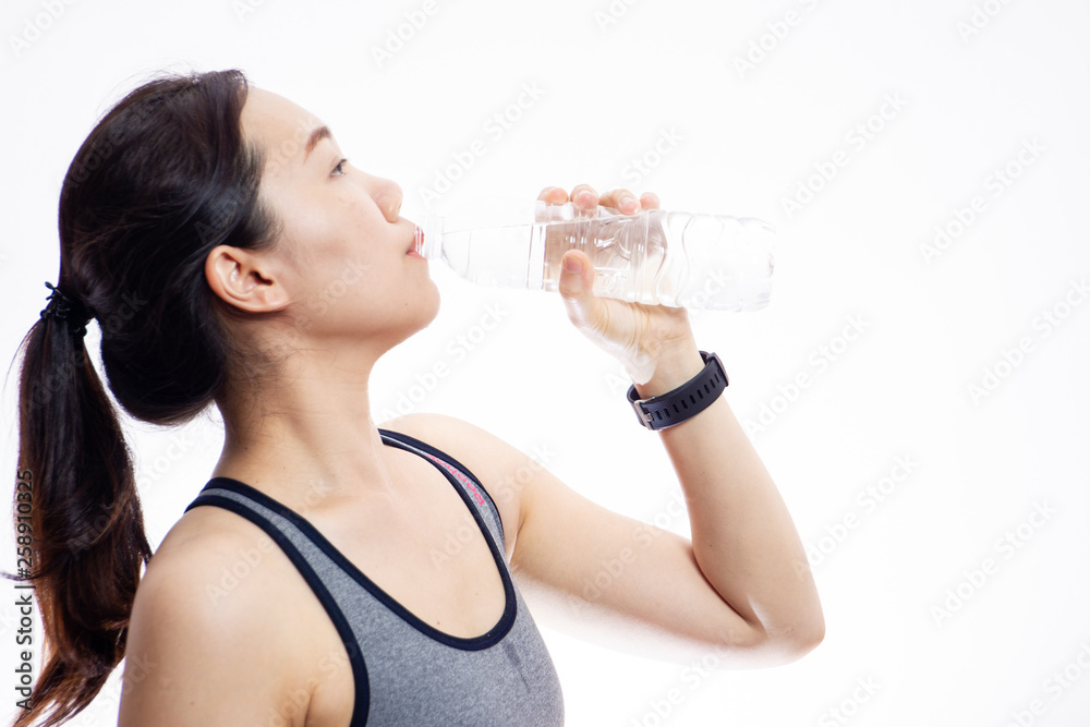 Beautiful Asian sport women drinking water in bottle close up on white background. Beautiful Asian sport women drinking water in bottle close up on white background.