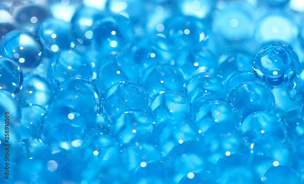 Water blue gel balls. Polymer gel. Silica gel. Balls of blue hydrogel. Crystal liquid ball with reflection. Texture background. Close up macro
