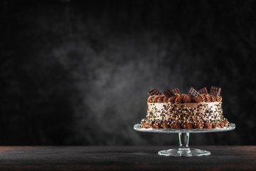 Decorated chocolate cake on dark background
