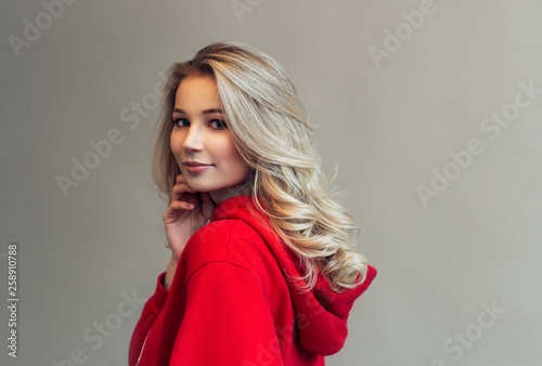 portrait of a young beautiful girl in a red sweatshirt