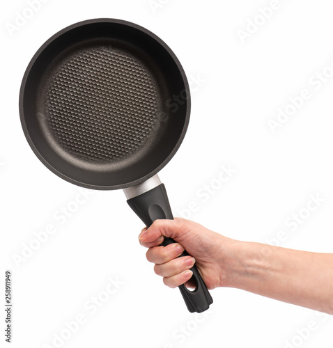 Female hand holding simple new empty Non-stick Frying Pan with black handle, isolated on white background.
