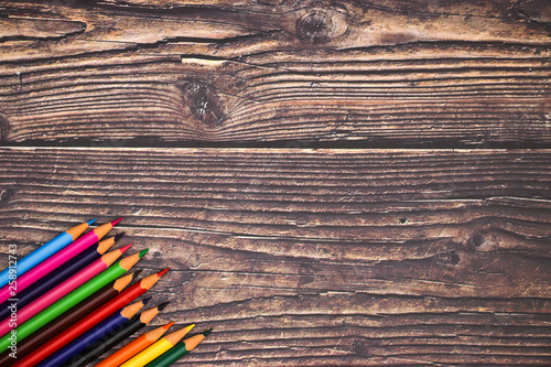 Colorful pencils on wooden background