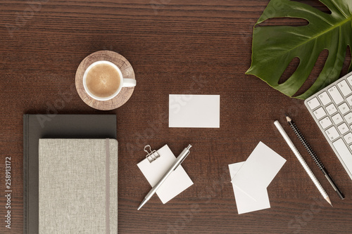 Canvas-taulu workspace  pen  pencil business card  notes notepad  coffee cub   paperclip  copy space  leaf monstera  top view with copy space for your text