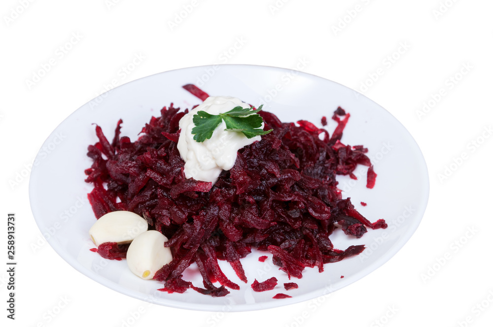 Grated beets with garlic in a plate close-up Grated beets with garlic in a plate close-up