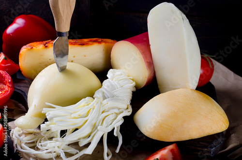 Assorted cheeses in various shapes and sizes photo