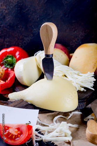 Assorted cheeses in various shapes and sizes photo