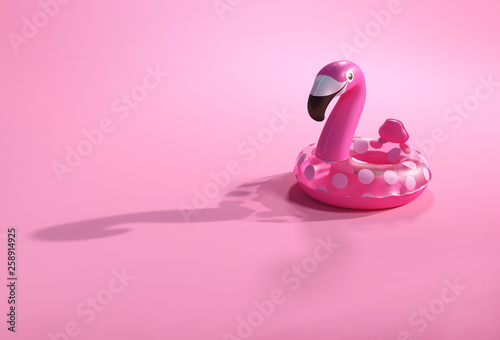Summer backgrounds. 3d flamingo shape inflatable swimming pool ring for floating. Vacation and traveling accessories for beach and sea.