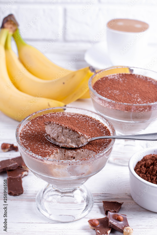 Coffee and chocolate dessert in a glass jar on the wooden table Coffee and chocolate dessert in a glass jar on the wooden table