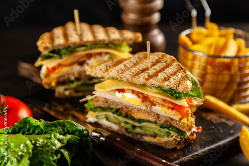 Tall club sandwich and french fries