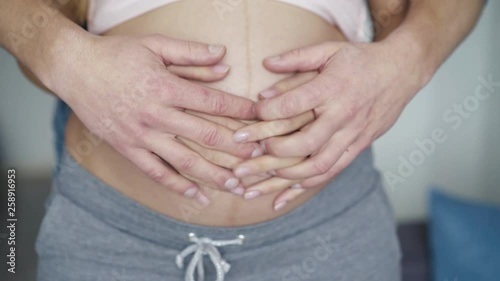Wallpaper Mural Close view of male and female hands caressing pregnant tummy at camera Torontodigital.ca