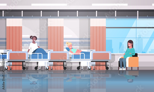 mix race pregnant women patients sitting in bed and armchair girls discussing communication pregnancy and motherhood concept modern clinic ward interior flat horizontal
