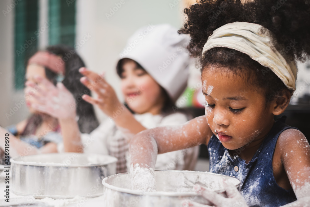 Group diversity kids girl making cake bakery in kitchen - obrazy, fototapety, plakaty 
