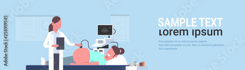 pregnant woman visiting female doctor doing ultrasound fetus screening at digital monitor gynecology consultation concept modern hospital clinic horizontal flat portrait copy space