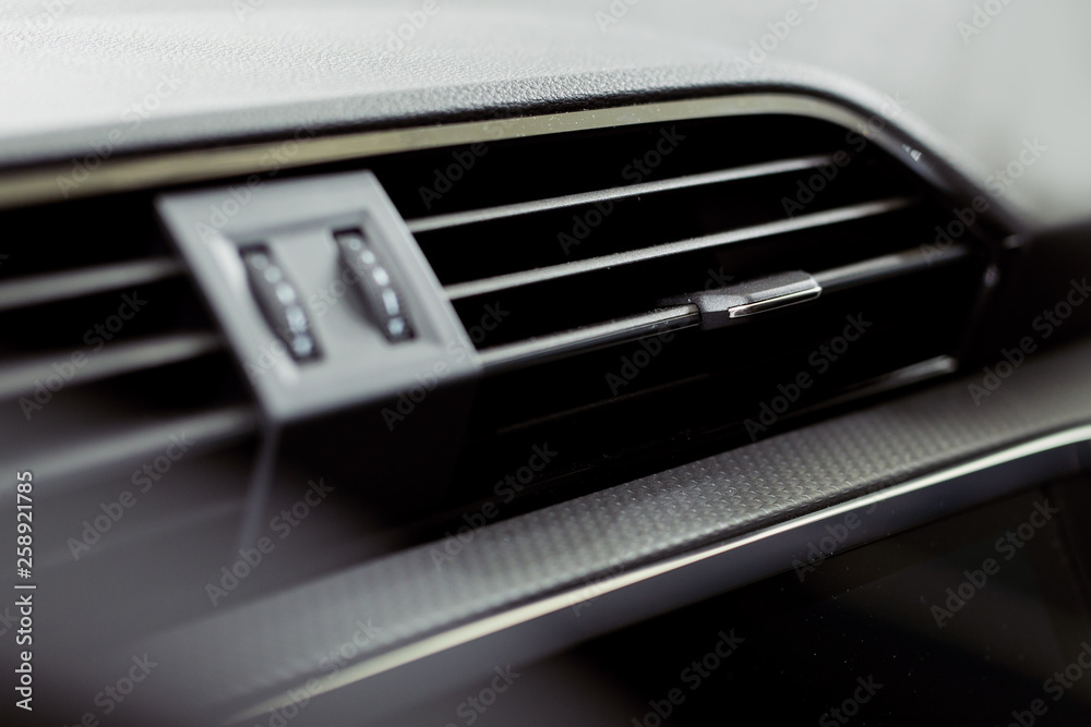 Modern car interior with close-up of ventilation system holes and air conditioning - Modern car interior with close-up of ventilation system holes and air conditioning -