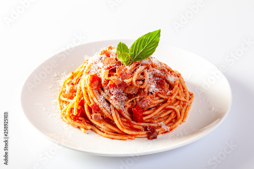 Fototapeta Spaghetti in a dish on a white background