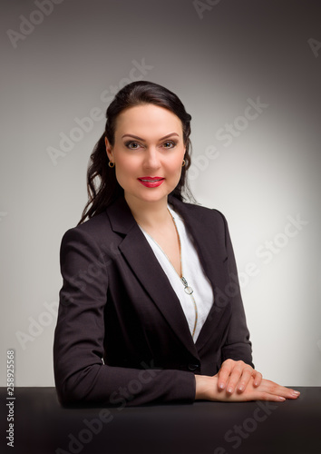 Portrait of wonderful business woman on gray background