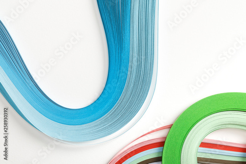 top view of wavy rainbow paper lines on white background