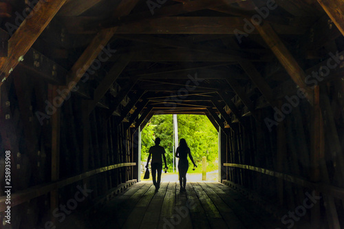 Sheffield, Massachusetts, USA A couple at the Sheffield Covered Bridge with their lunch. © Alexander