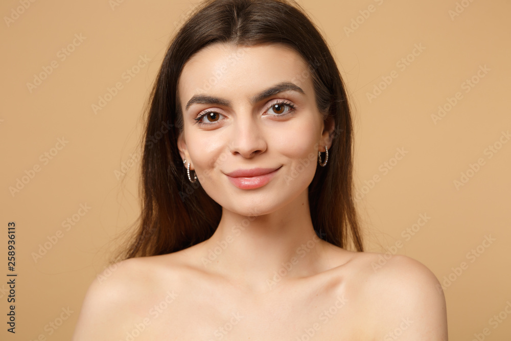 Close up brunette half naked woman 20s with perfect skin, nude make up  isolated on beige pastel wall background, studio portrait. Skin care  healthcare cosmetic procedures concept. Mock up copy space. Photos