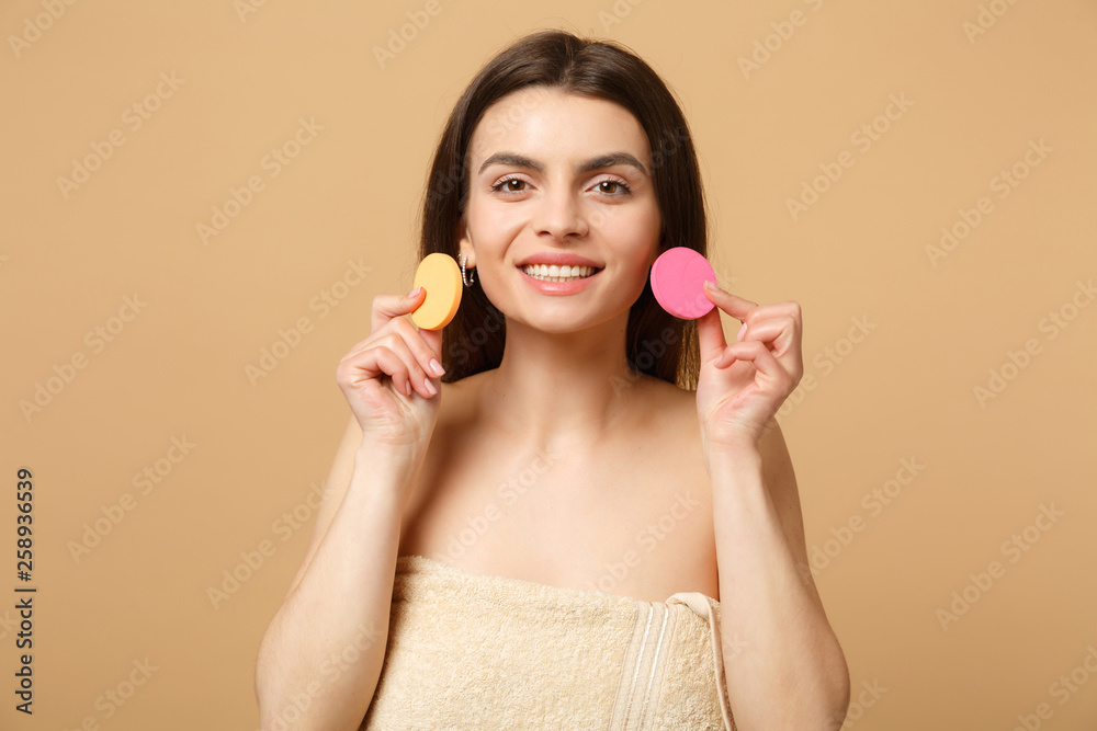 Close up brunette half naked woman 20s with perfect skin, removing nude make up isolated on beige pastel wall background, studio portrait. Health care cosmetic procedures concept. Mock up copy space. Close up brunette half naked woman 20s with perfect skin, removing nude make up isolated on beige pastel wall background, studio portrait. Health care cosmetic procedures concept. Mock up copy space.