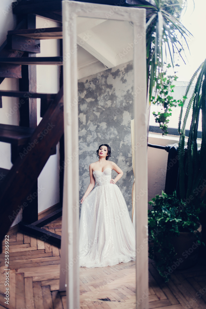 Fototapeta premium beautiful bride brunette looks in the mirror 