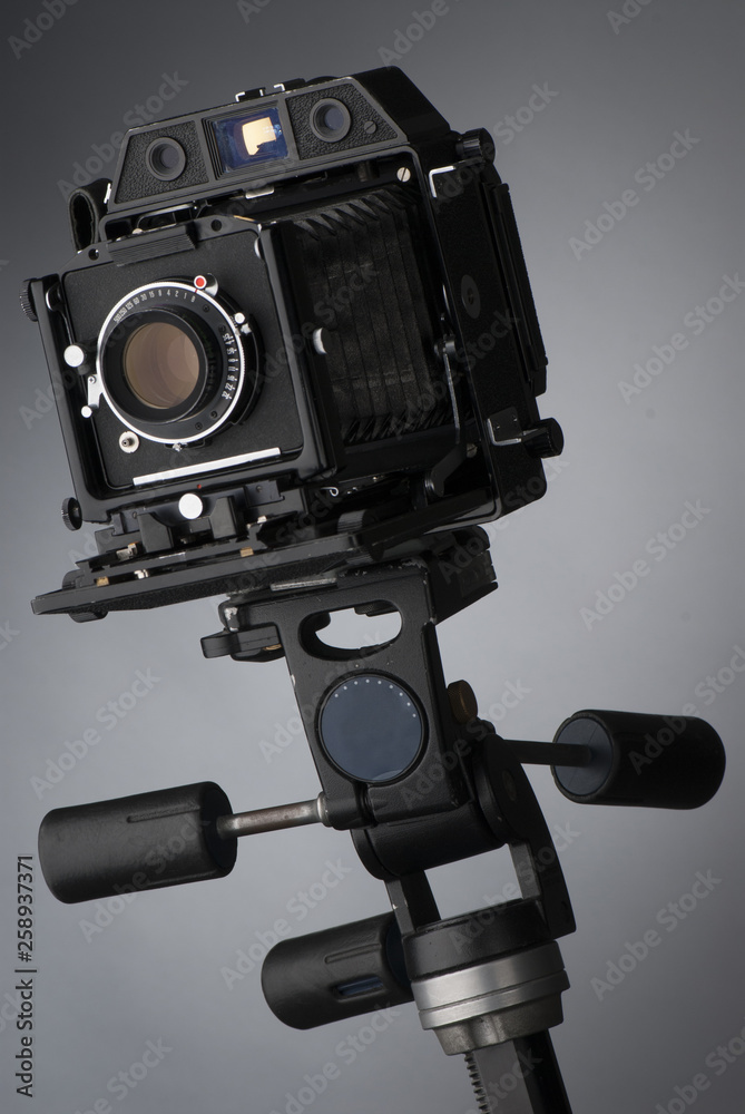 An old professional camera on gray background