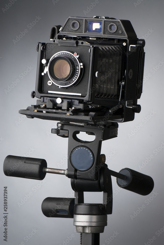 An old professional camera on gray background