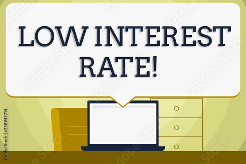 Conceptual hand writing showing Low Interest Rate. Concept meaning Manage money wisely pay lesser rates save higher Blank Huge Speech Bubble Pointing to the White Laptop Screen