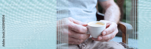 Man holding a cup of coffee. panoramic banner