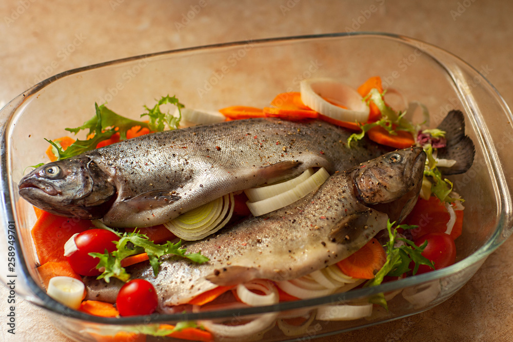 Fresh sea fish with spices and vegetable ingredients on wooden table, cooking concept. Fresh sea fish with spices and vegetable ingredients on wooden table, cooking concept.