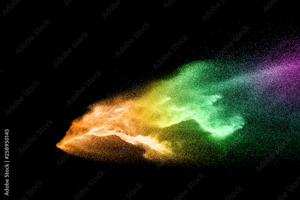 Fototapeta premium Abstract colorful powder explosion on black background.Freeze motion of dust splash.Painted Holi.