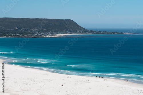 Horse riders taking a stroll on beach at Noordhoek, Western Cape photo