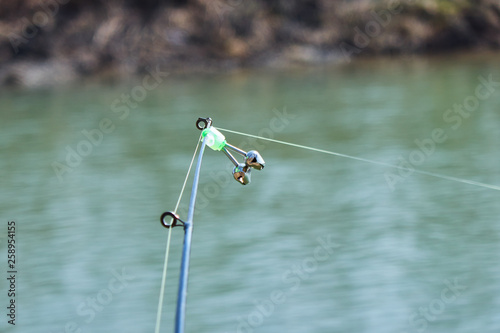 Fishing bell at the end of a fishing rod. Bells will ring when the fish is hooked