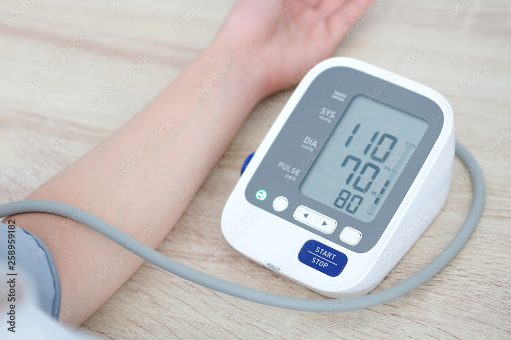 Man check blood pressure monitor and heart rate monitor with digital pressure gauge. Health care and Medical concept Man check blood pressure monitor and heart rate monitor with digital pressure gauge. Health care and Medical concept