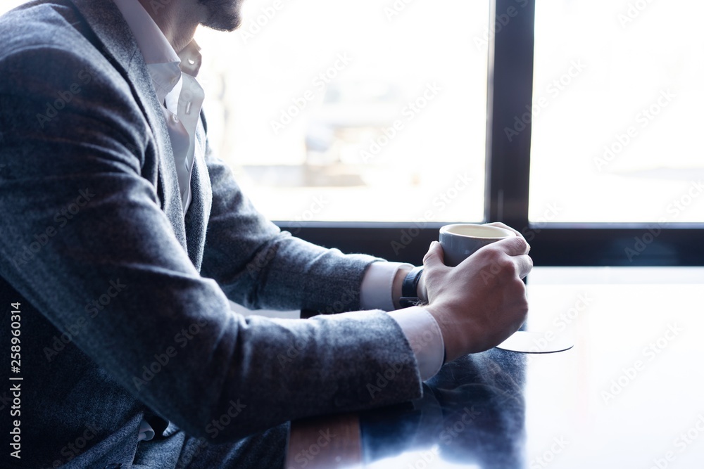 Take a break and have coffee. Business man drinking coffee in a cafe.