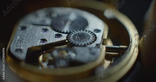 Old clock mechanical part starting process white lightning from right side macro side view ProRes 4444