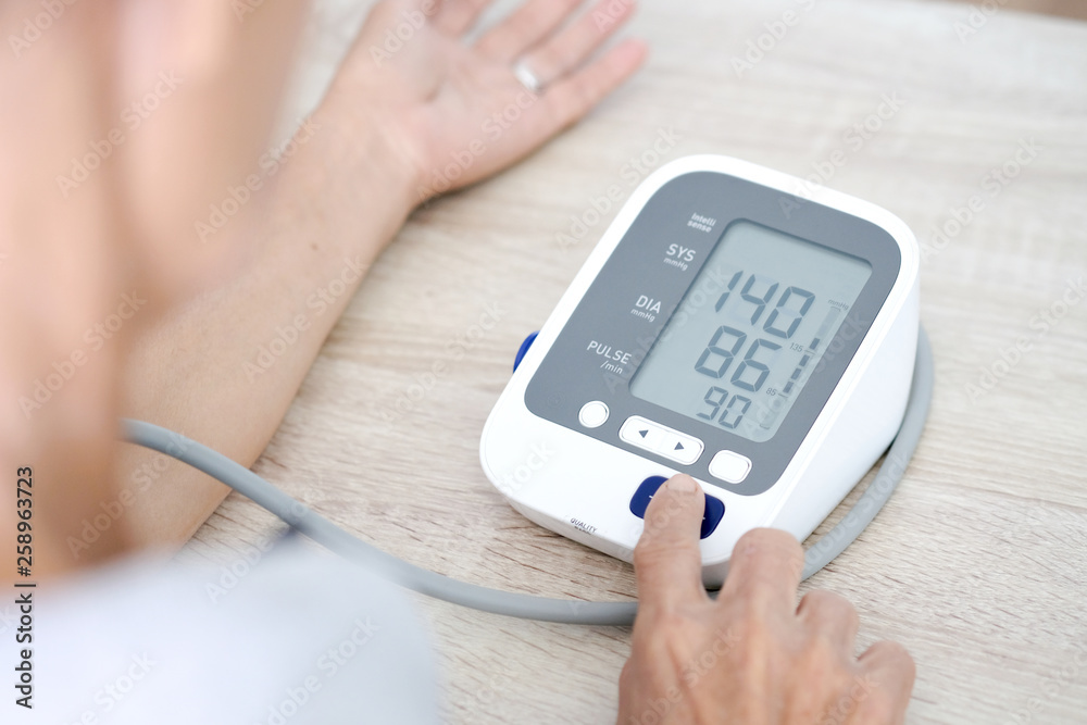 Man check blood pressure monitor and heart rate monitor with digital pressure gauge. Health care and  Medical concept
