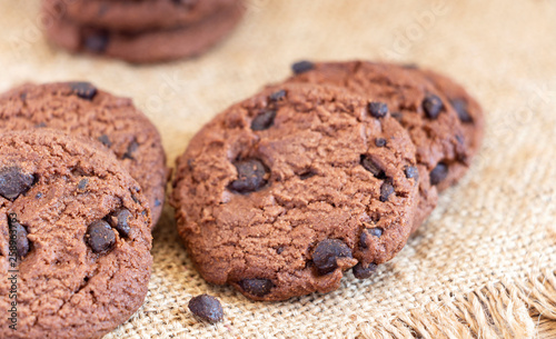 Chocolate chip cookies on sackcloth on the table. Copy space for your text or image.