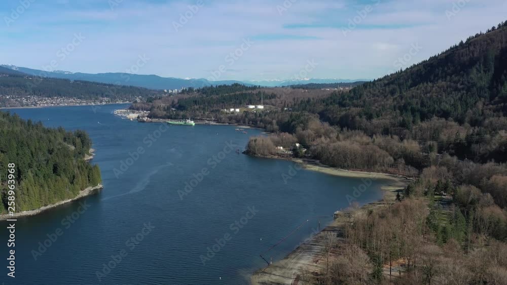 Aerial view over Burrard Inlet, ocean and island with boat and mountains in beautiful British Columbia. Canada. 4K. Aerial view over Burrard Inlet, ocean and island with boat and mountains in beautiful British Columbia. Canada. 4K.