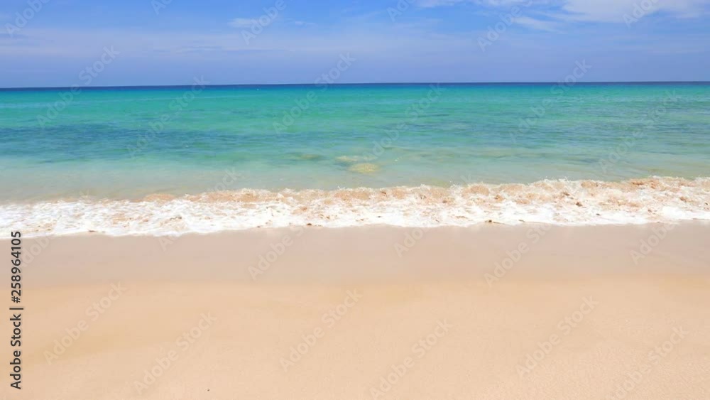 Waves gently roll in on a beautiful, tropical beach. Waves gently roll in on a beautiful, tropical beach.