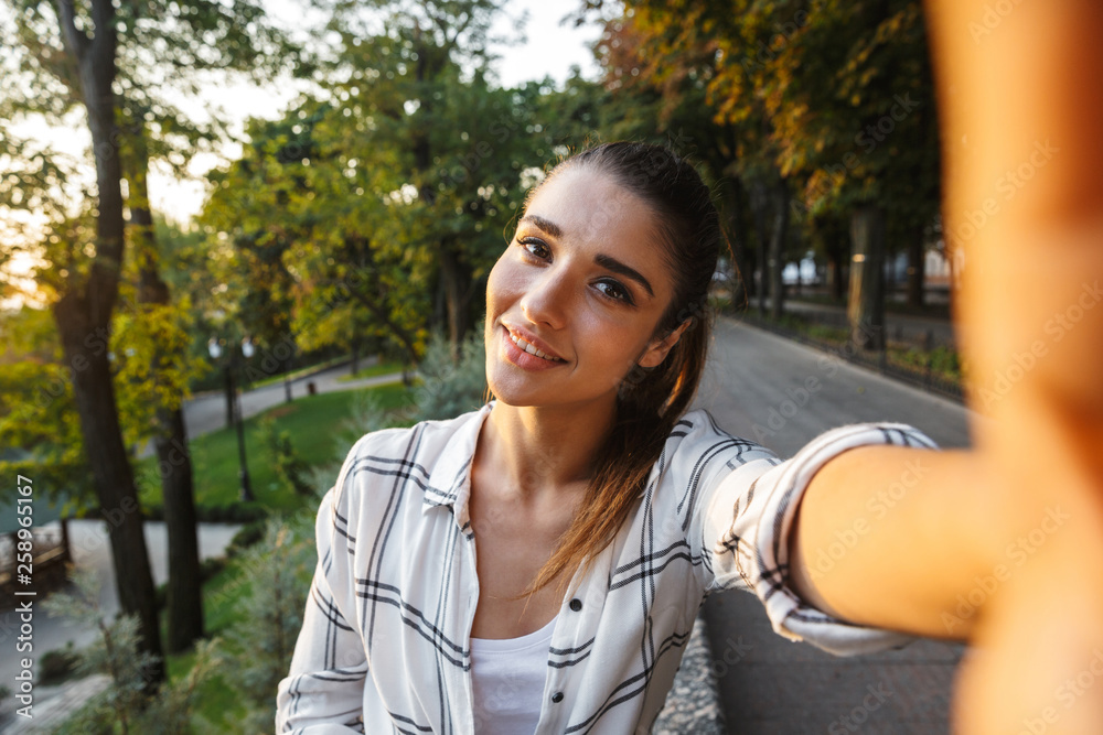 Lovely young student girl sitting outdoors Lovely young student girl sitting outdoors