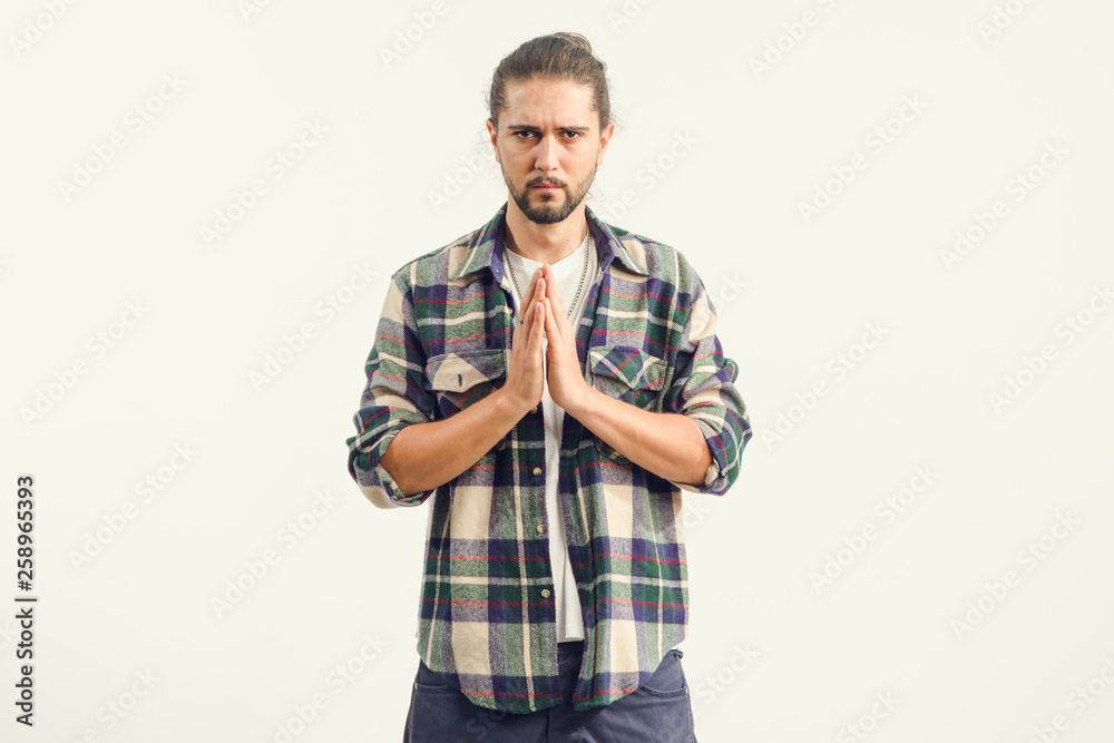 Young man praying he holds his palms in front of him. Meditation and concentration. Young man praying he holds his palms in front of him. Meditation and concentration.